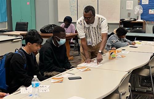 DPSCD representative explaining the voter registration to high school students